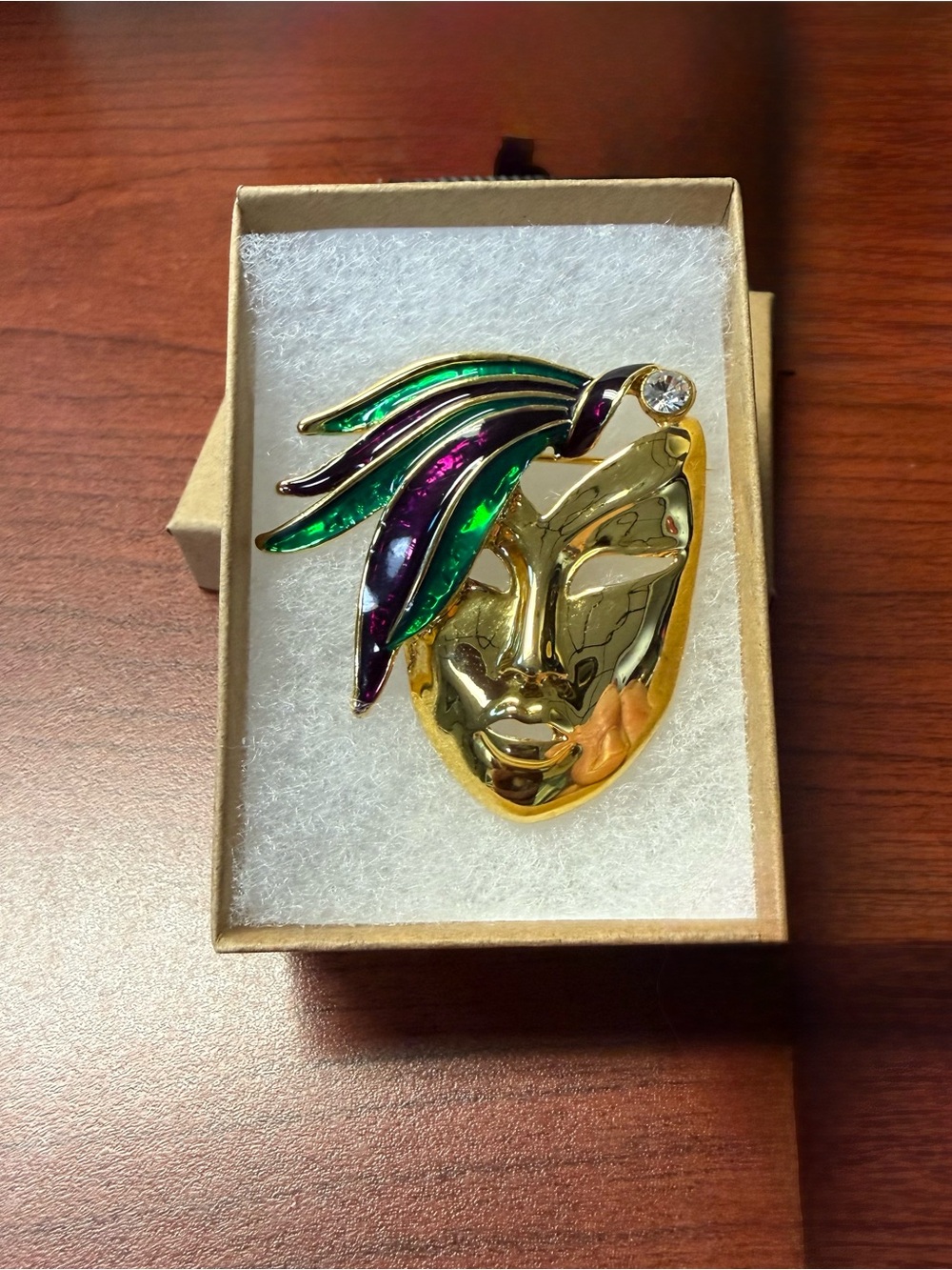 Mardi Gras Gold-tone Mask Brooch accented by sparkling clear rhinestone